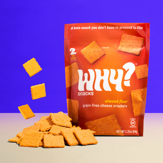 Why? Snacks grain-free cheese crackers bag, with pile of crackers in front.